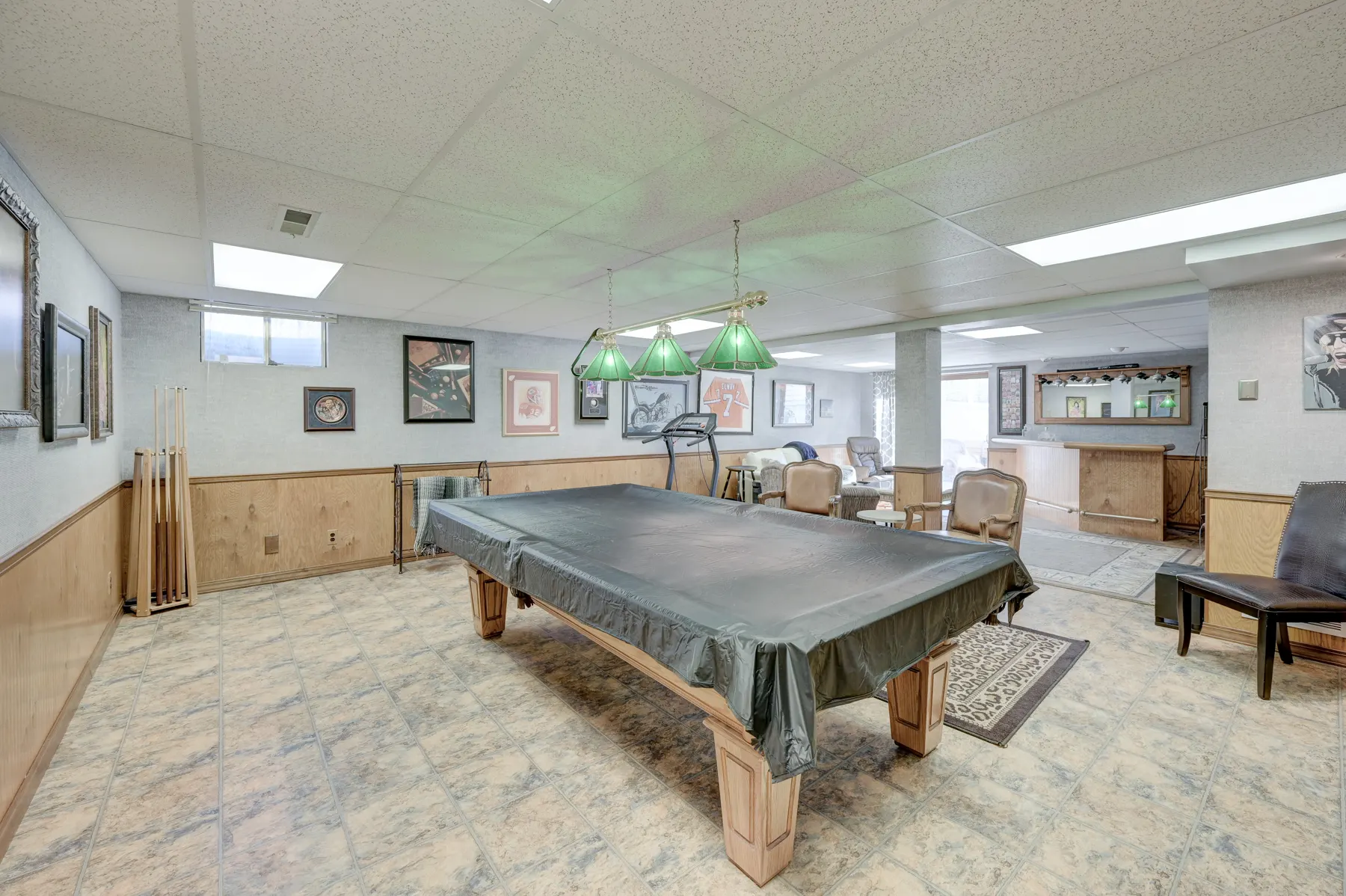 Finished basement recreation room with a pool table