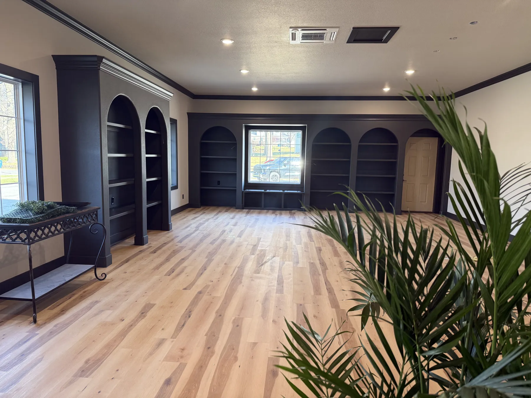 Florette interior during construction, with new arched built-in shelving, crown molding and light wood floors installed