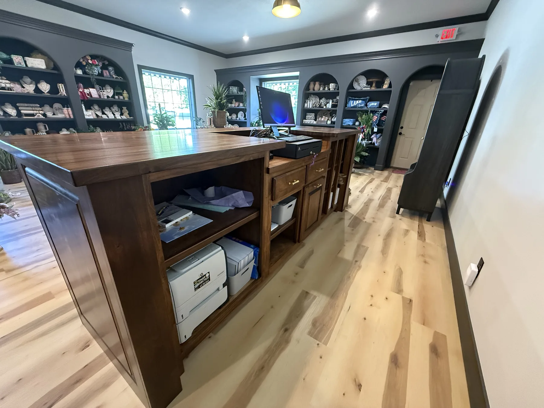 Finished Florette interior with a walnut sales counter, arched display shelving and light wood floors