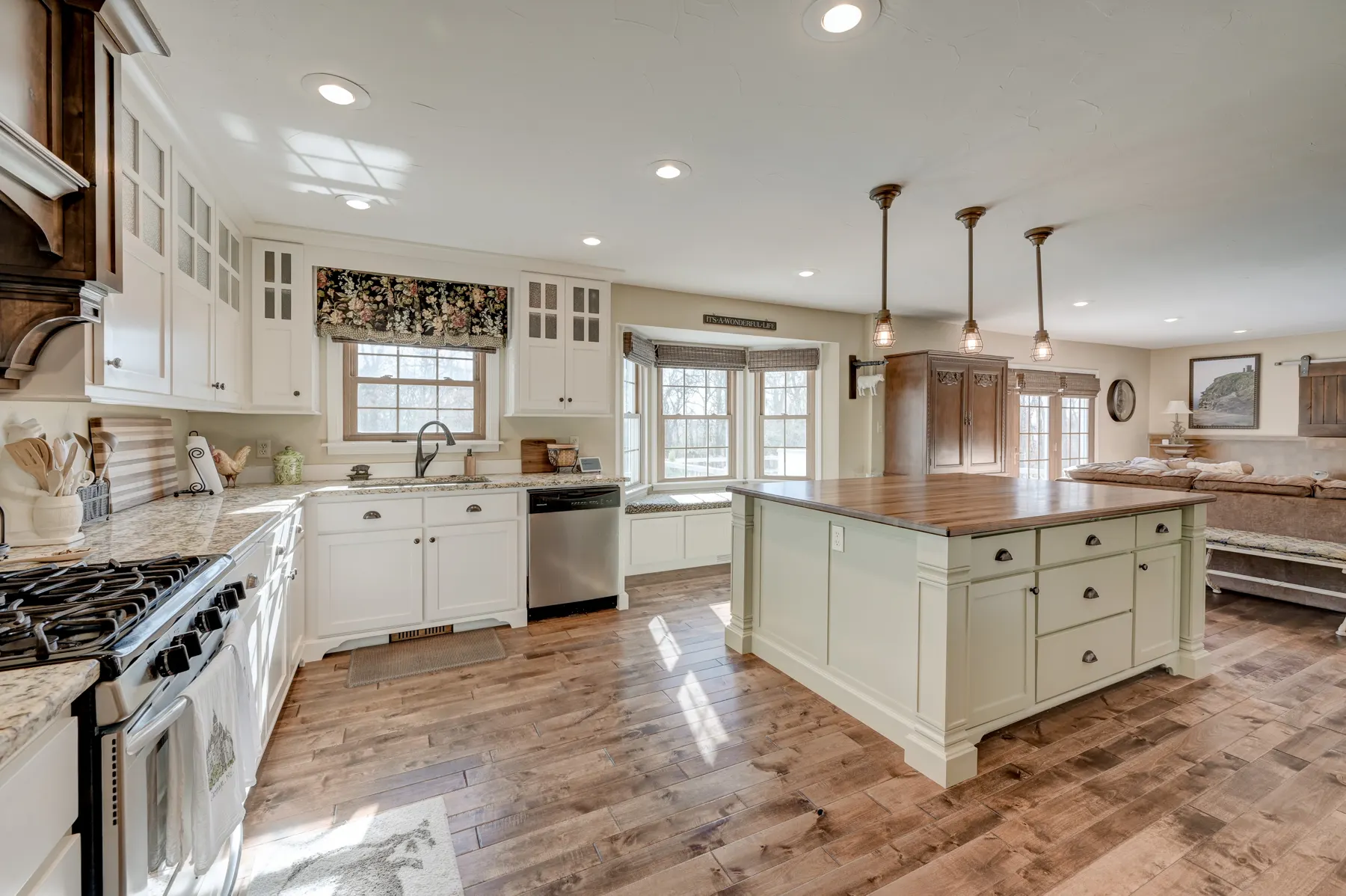 Bright white kitchen with an island and pendant lights