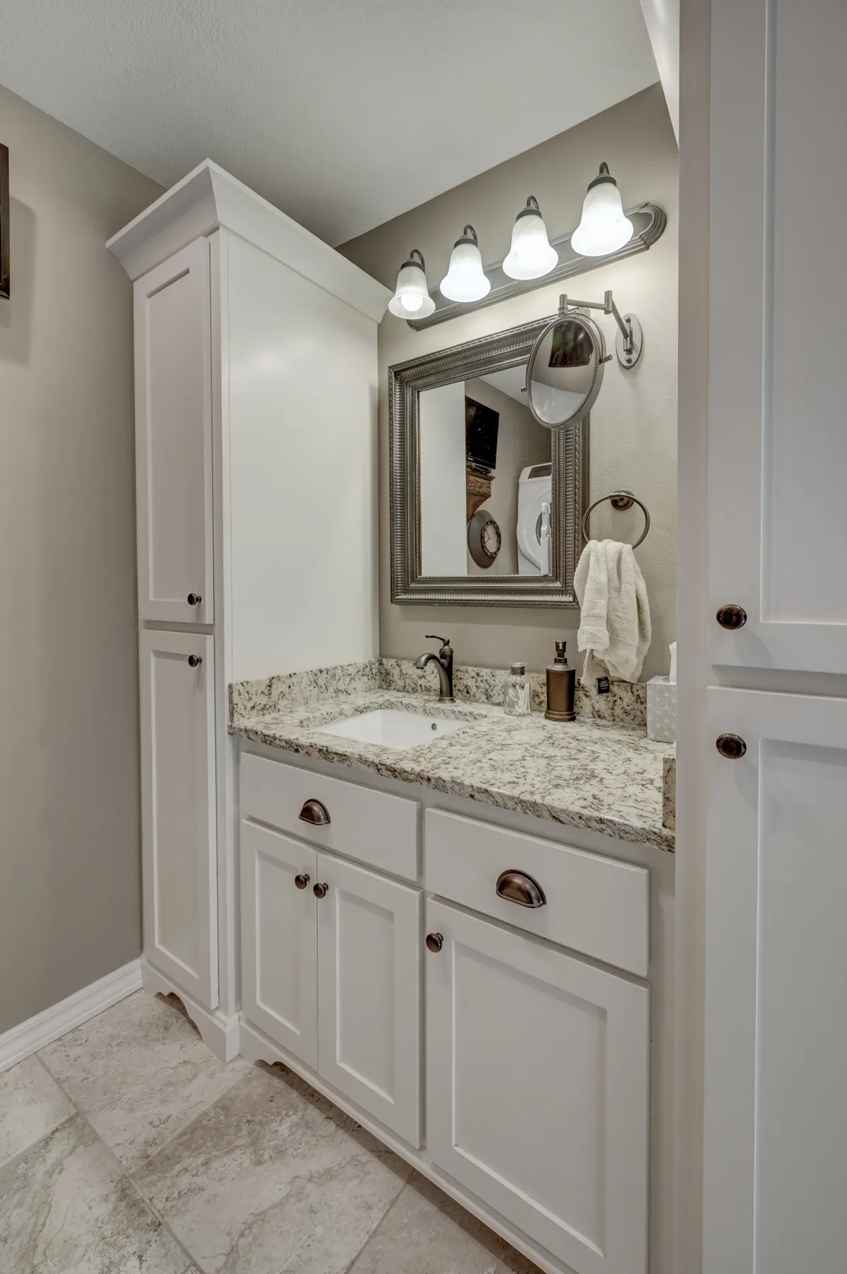 White vanity with tall linen cabinet