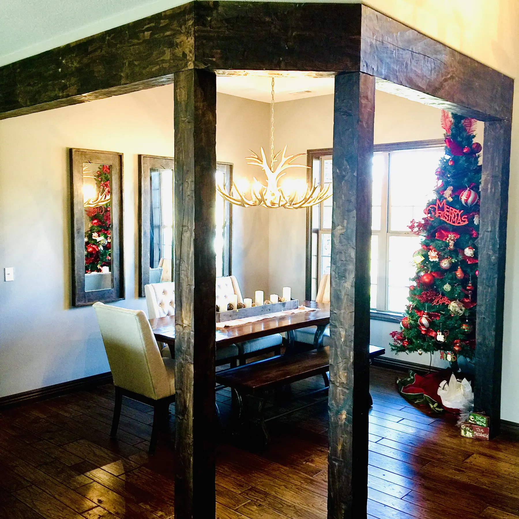 Dining room framed by dark timber posts and beams