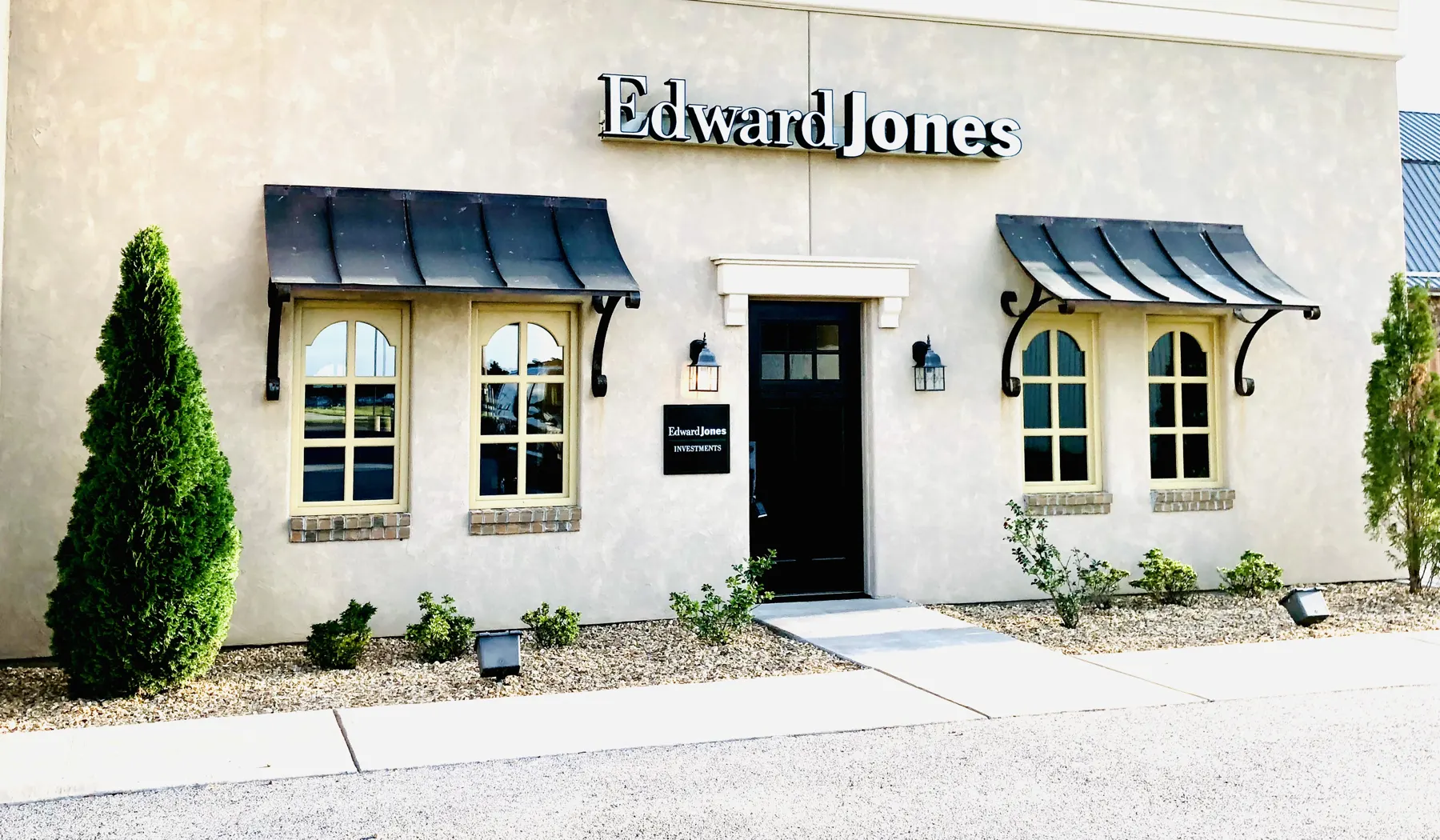Edward Jones office exterior with black awnings and arched windows