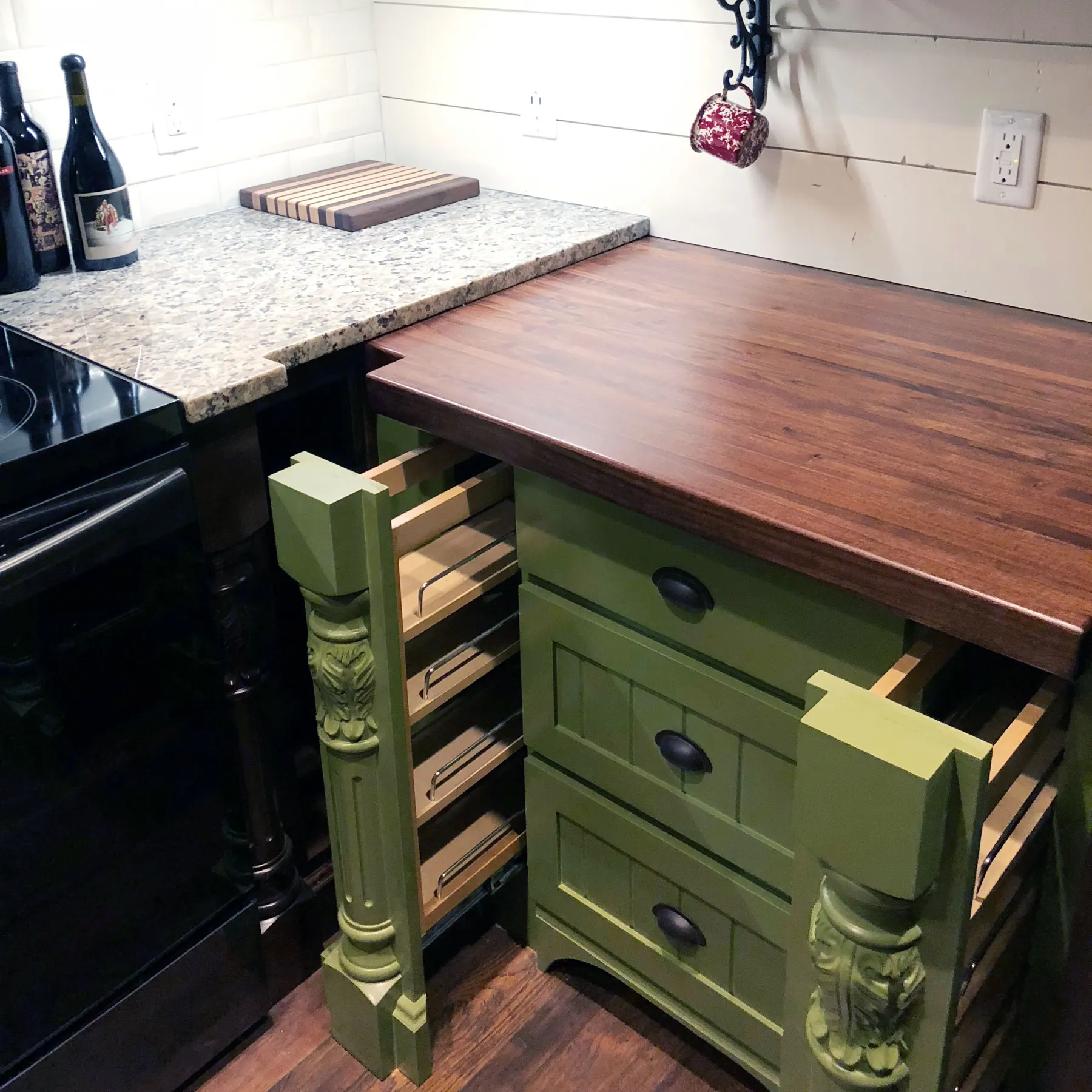 Custom green cabinet with pull-out drawers, carved legs and a walnut top