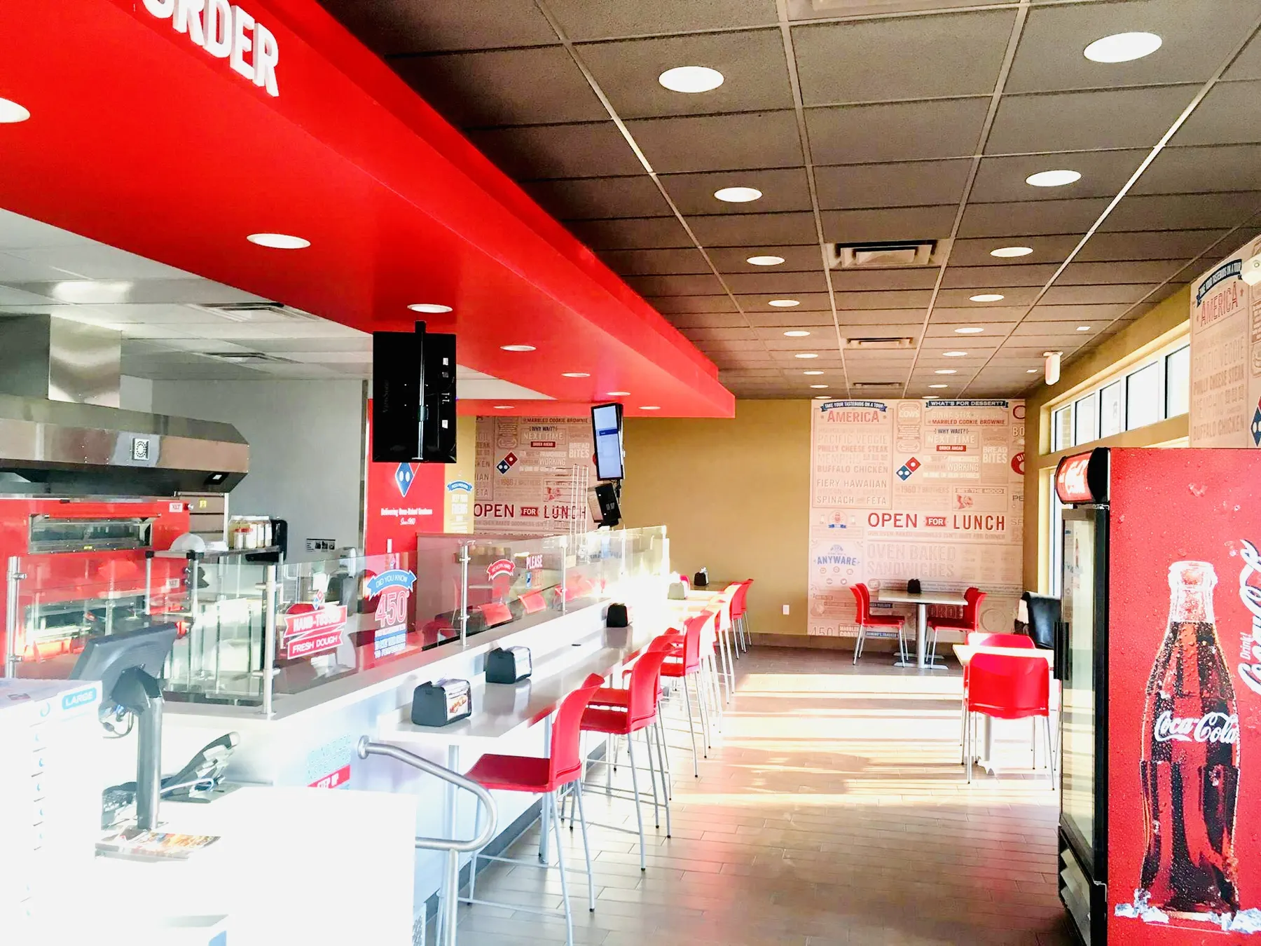 Restaurant interior with a red ceiling canopy and counter seating