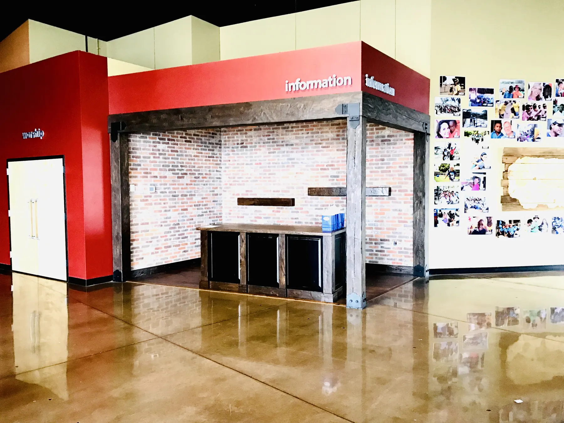 Retail interior with a red feature wall and stained concrete floor