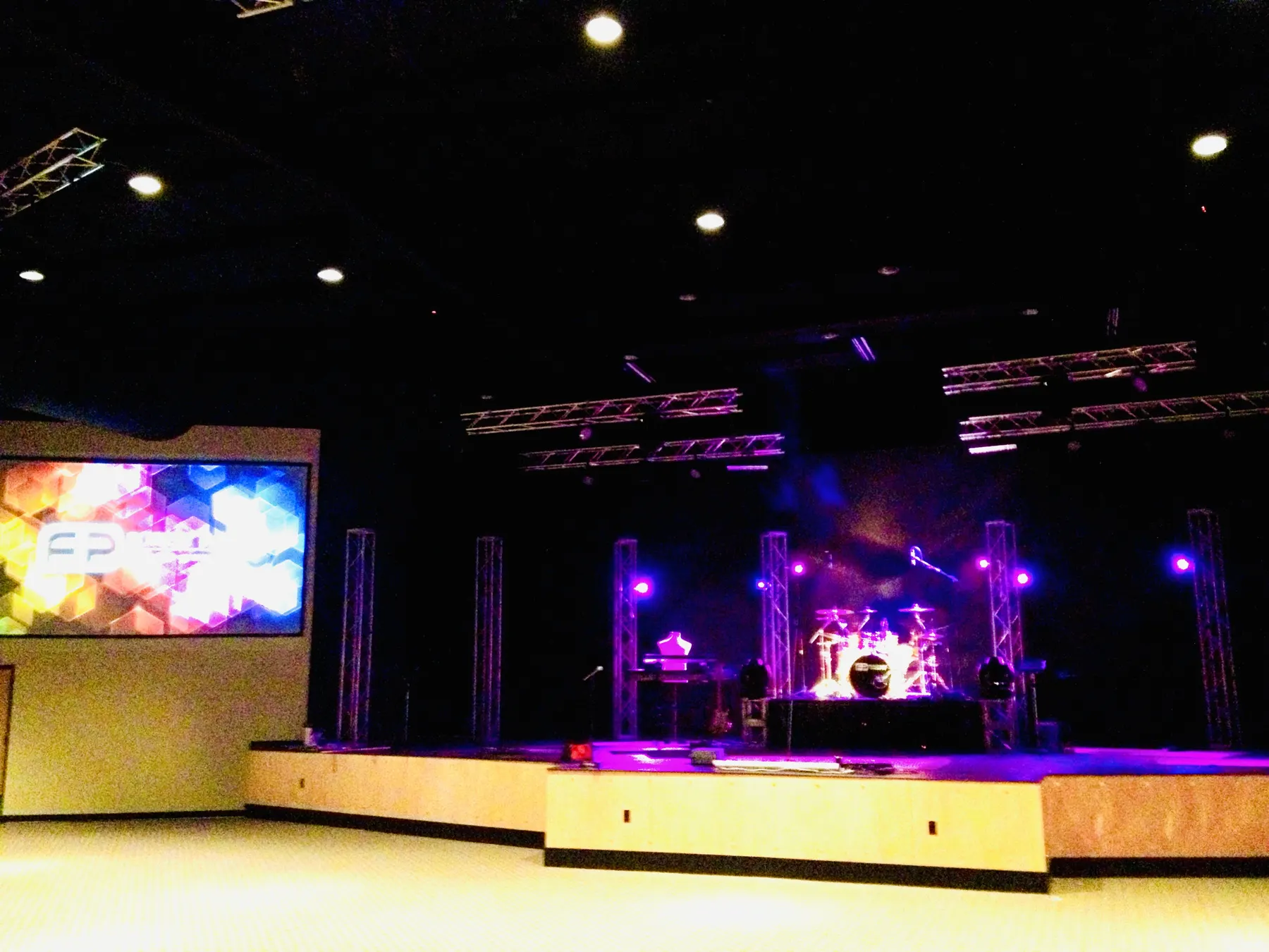 Church stage with lighting truss and a large screen