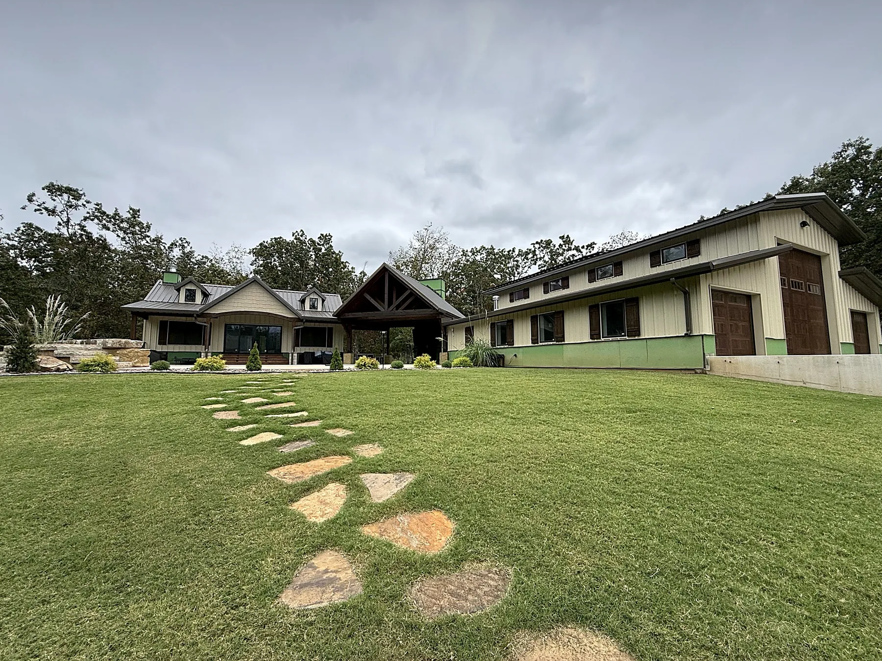 New lawn and stepping-stone path leading to the pool house, pavilion and shop