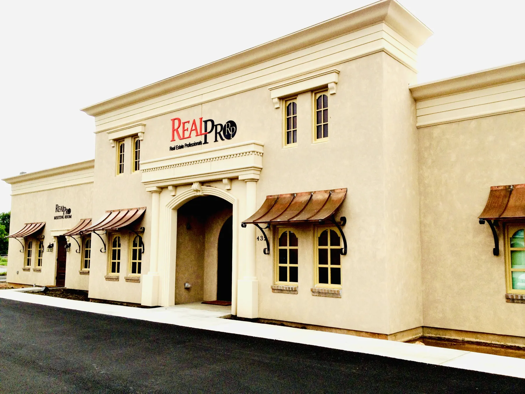 Commercial office building with stucco facade and awnings
